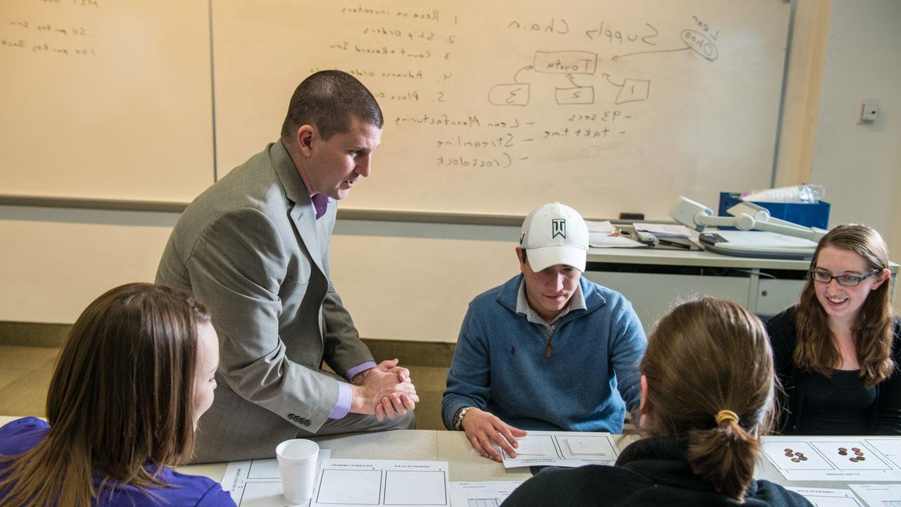 Faculty with students in Supply Chain Management course