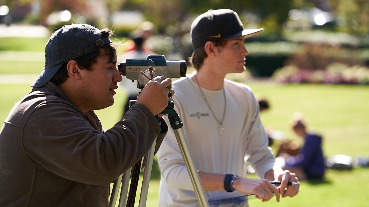 Civil Engineering students conduct a survey on campus.