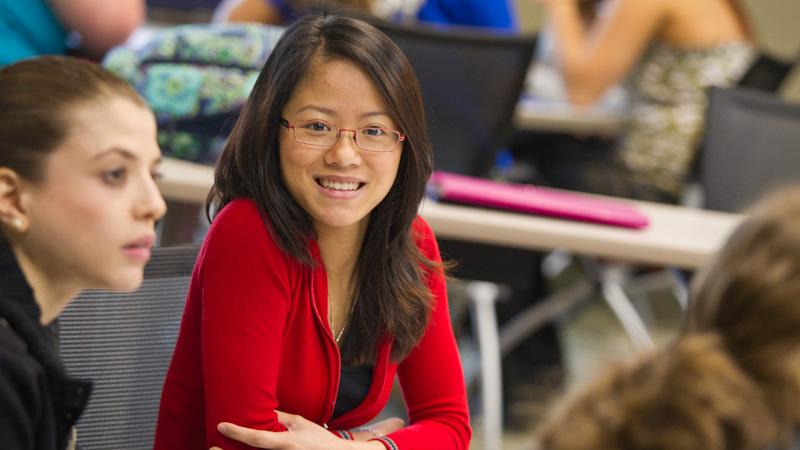 UE student in class smiling