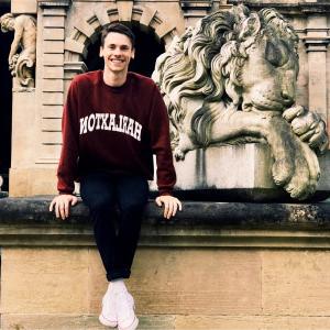 Andrew sitting on front of Harlaxton Manor